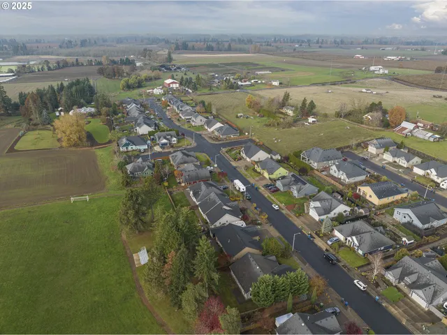 an aerial view of ocean with residential houses with outdoor space