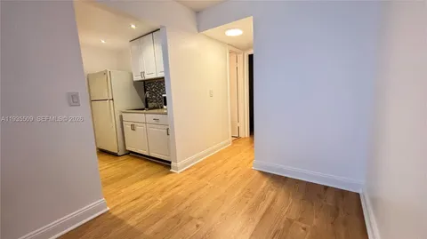 a view of kitchen with wooden floor electronic appliances and window