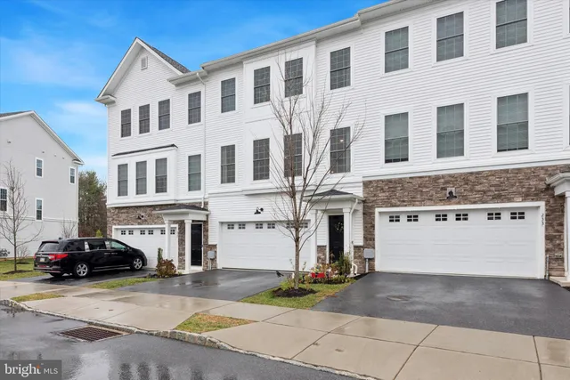 a view of a building with car parked on the road