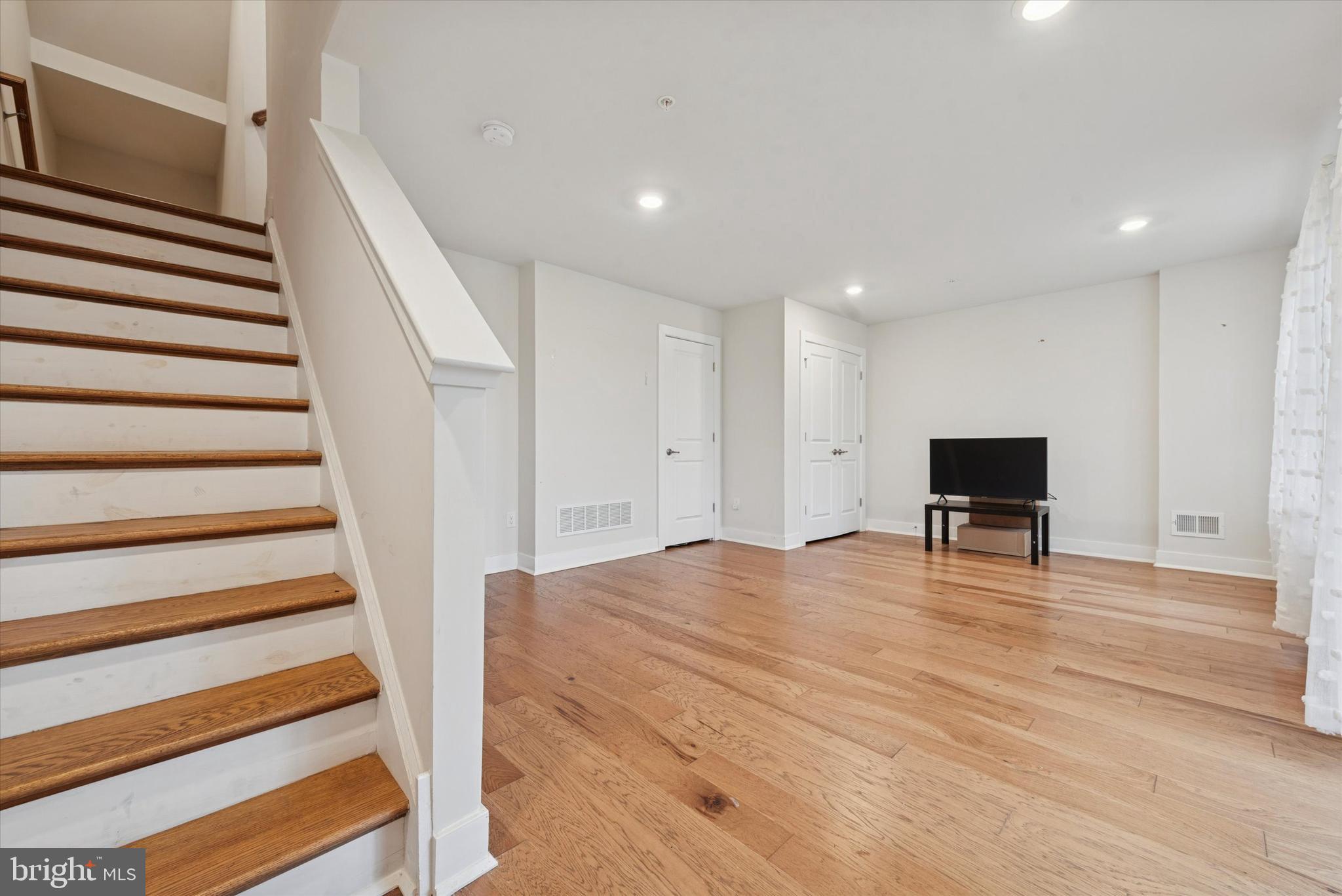 235 Red Leaf Lane Exton, PA 19341 - Photo 21 of 25 a view of an empty room with wooden floor and stairs