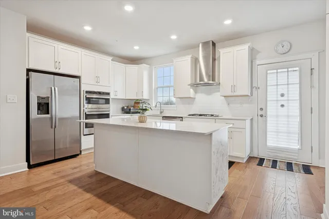 a kitchen with stainless steel appliances granite countertop a refrigerator sink and cabinets