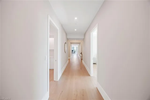 a large white room with a mirror and a sink