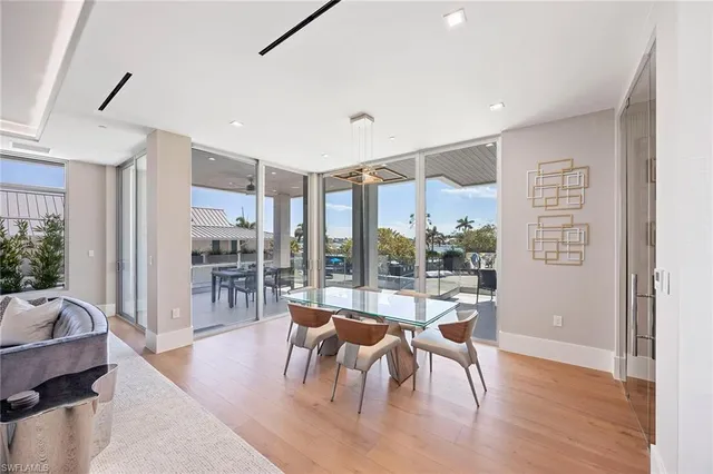 a dining room with furniture and wooden floor
