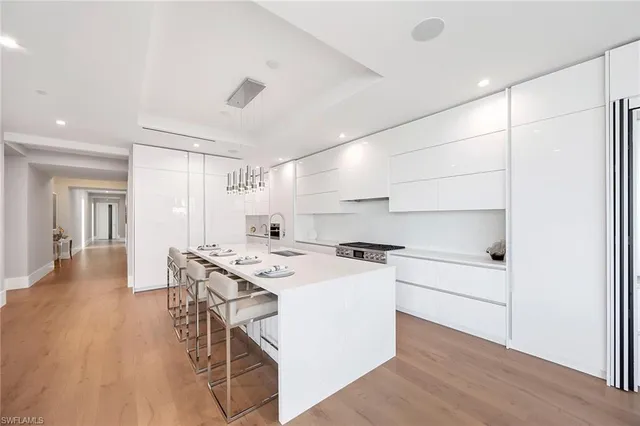 a kitchen with a stove a table and chairs