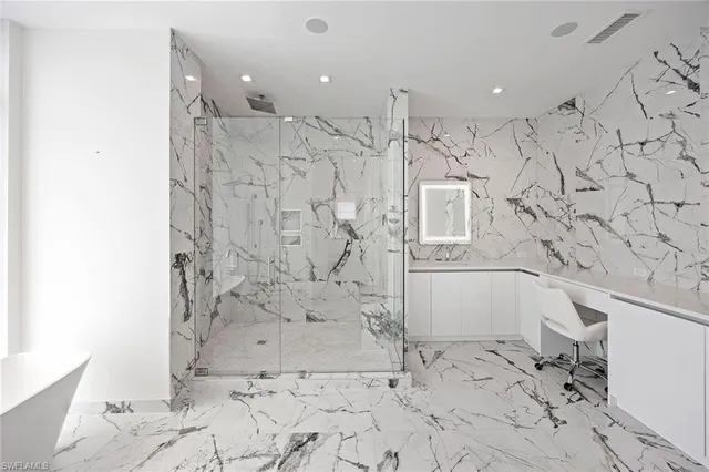 a bathroom with a bathtub and shower