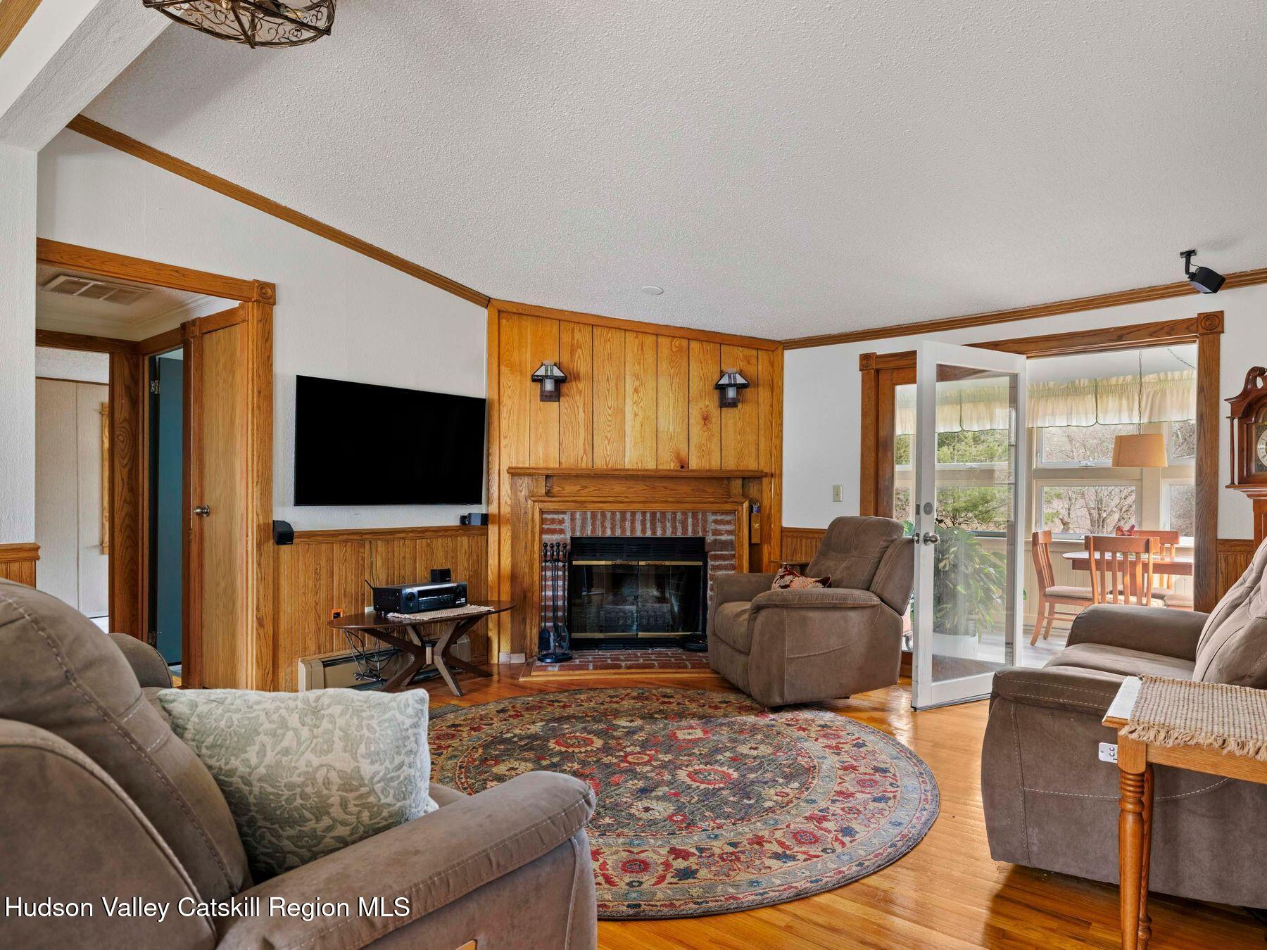 382 Cairo Junction Road Catskill, NY 12414 - Photo 17 of 38 a living room with furniture a flat screen tv and a fireplace
