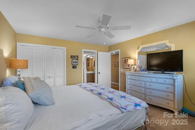 a bedroom with a bed a table and chair