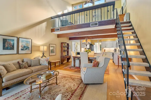 a living room with furniture and a floor to ceiling window