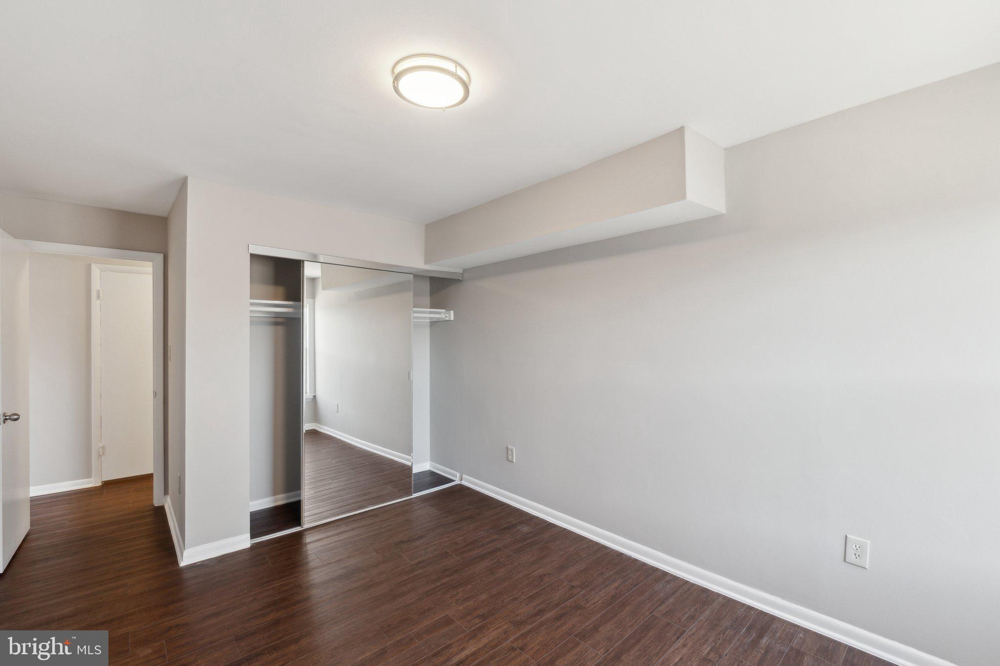 3809 St Barnabas Road, Unit T202 Suitland, MD 20746 - Photo 15 of 20 a view of an empty room with wooden floor