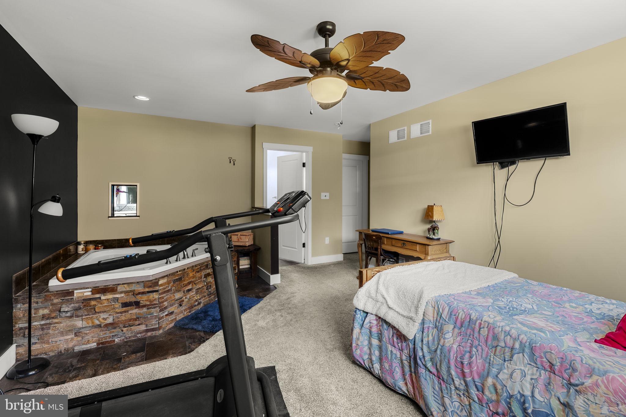 744 Lime Quarry Road Gap, PA 17527 - Photo 44 of 76 a bedroom with a bed and a flat screen tv