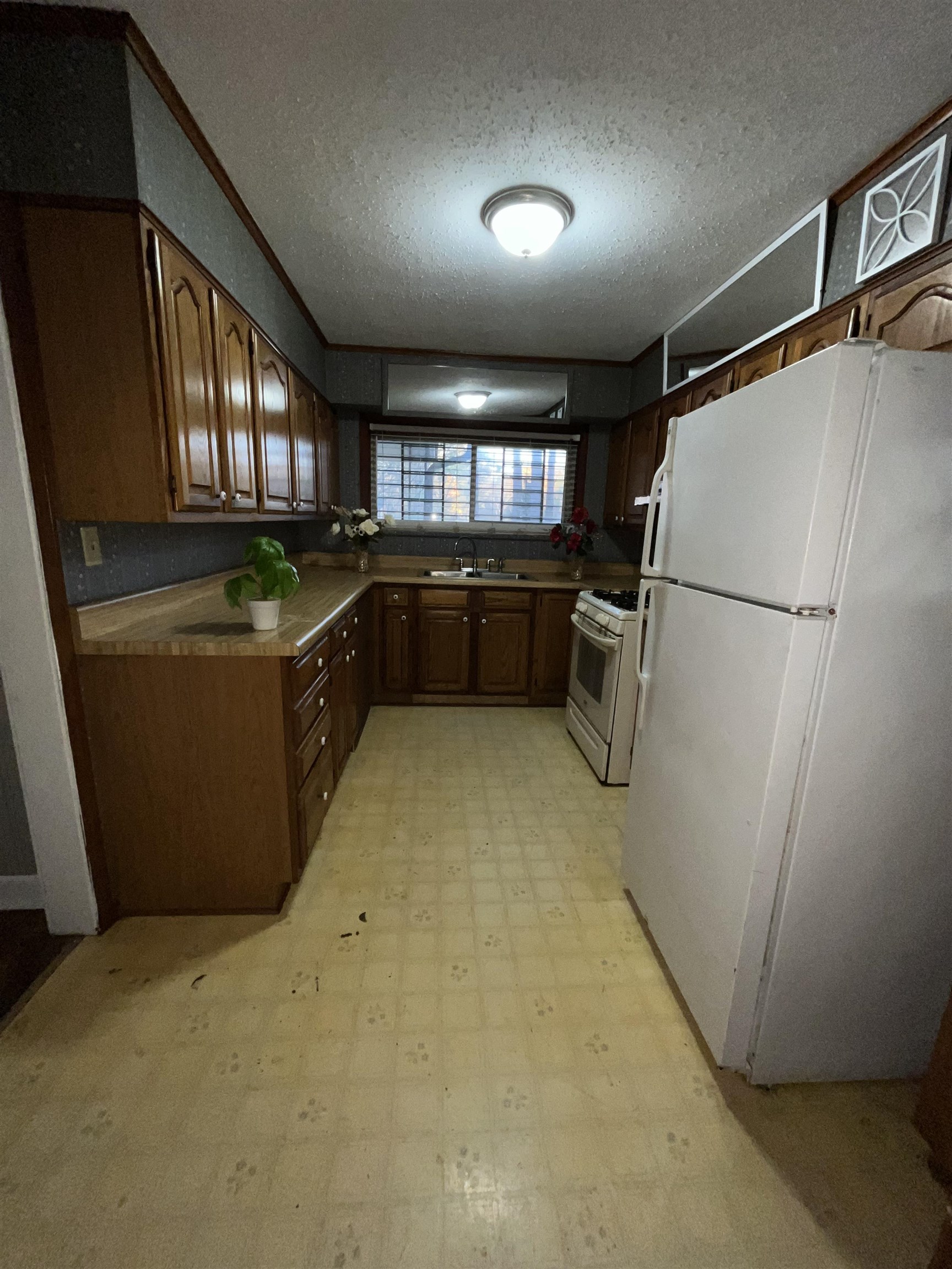 4297 Prescott Road Memphis, TN 38118 - Photo 8 of 14 a kitchen with a refrigerator and a counter top