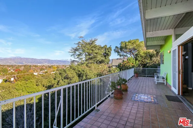 a view of a balcony with wooden floor