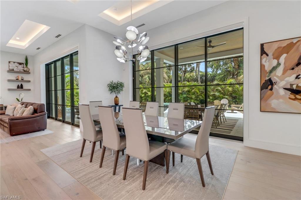 1546 Mandarin Road Naples, FL 34102 - Photo 14 of 48 Dining area featuring light hardwood / wood-style floors and a notable chandelier