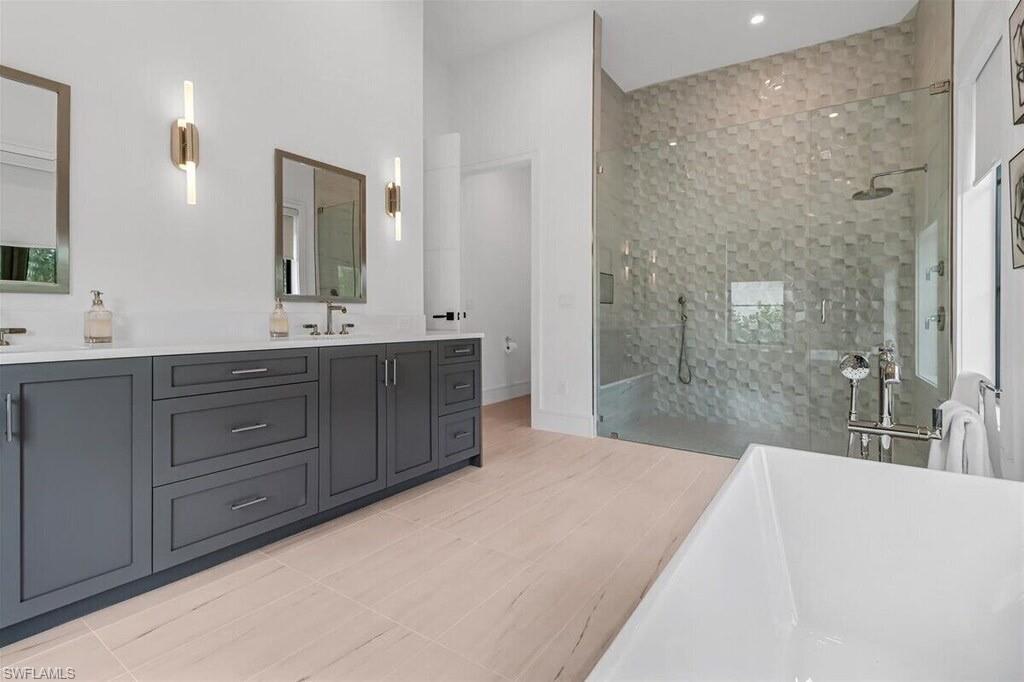 1546 Mandarin Road Naples, FL 34102 - Photo 21 of 48 Bathroom featuring vanity, tile patterned floors, and tiled shower