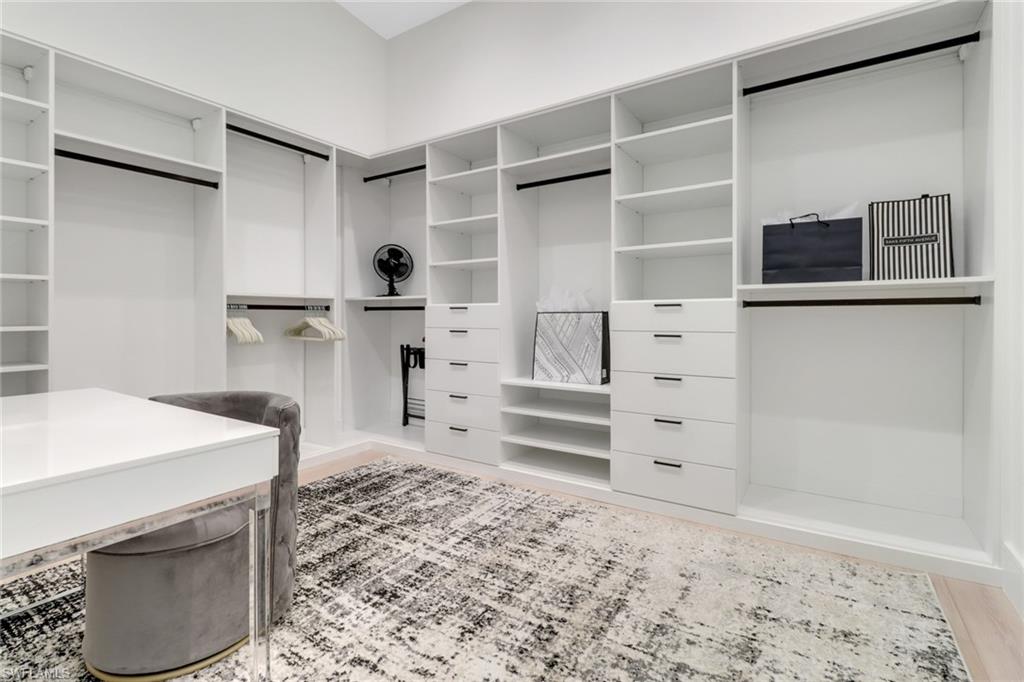 1546 Mandarin Road Naples, FL 34102 - Photo 22 of 48 Walk in closet featuring wood-type flooring
