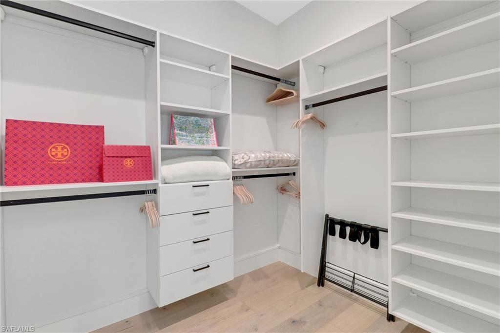 1546 Mandarin Road Naples, FL 34102 - Photo 26 of 48 Walk in closet with light hardwood / wood-style floors