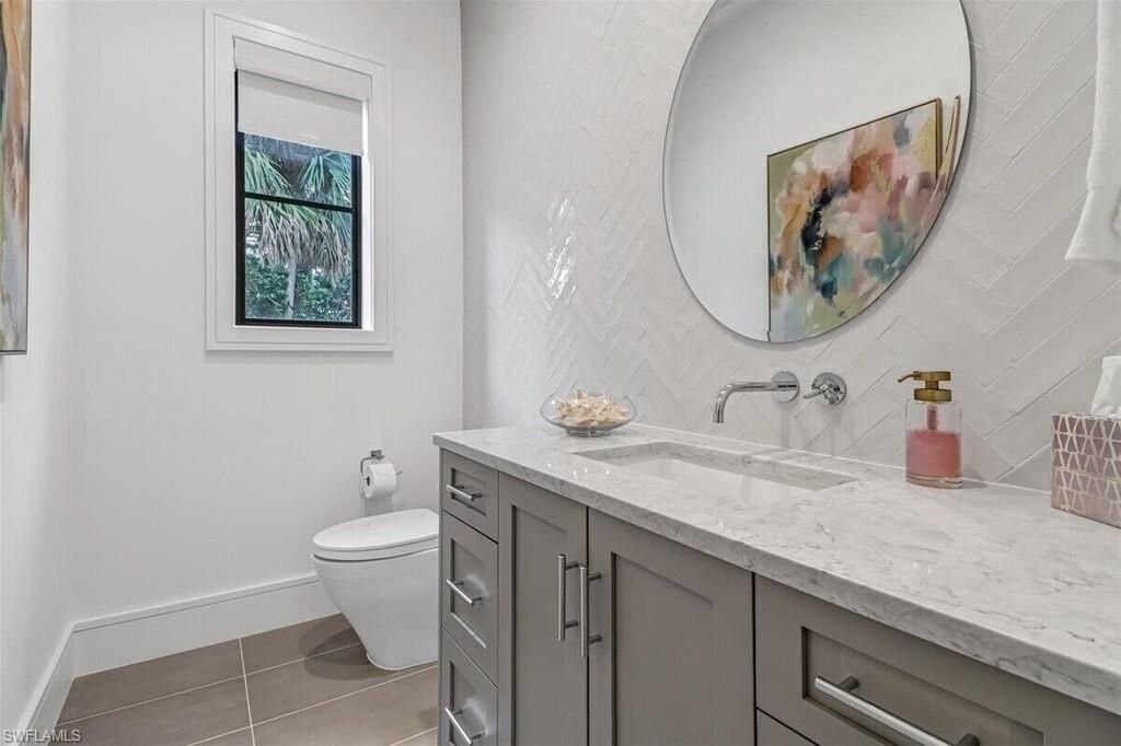 1546 Mandarin Road Naples, FL 34102 - Photo 27 of 48 Bathroom featuring vanity, toilet, and tile patterned flooring