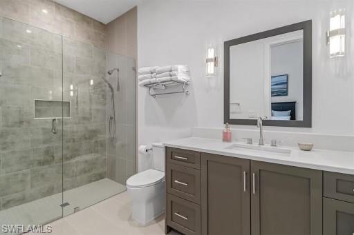 1546 Mandarin Road Naples, FL 34102 - Photo 29 of 48 Bathroom featuring vanity, toilet, walk in shower, and tile patterned flooring