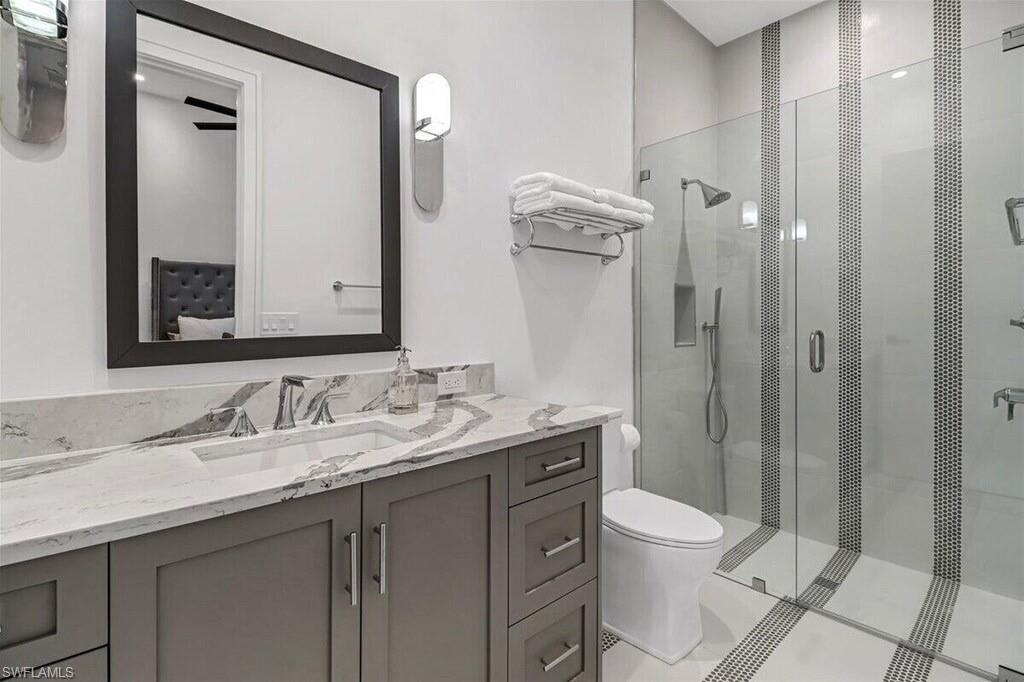 1546 Mandarin Road Naples, FL 34102 - Photo 31 of 48 Bathroom with vanity, an enclosed shower, and toilet