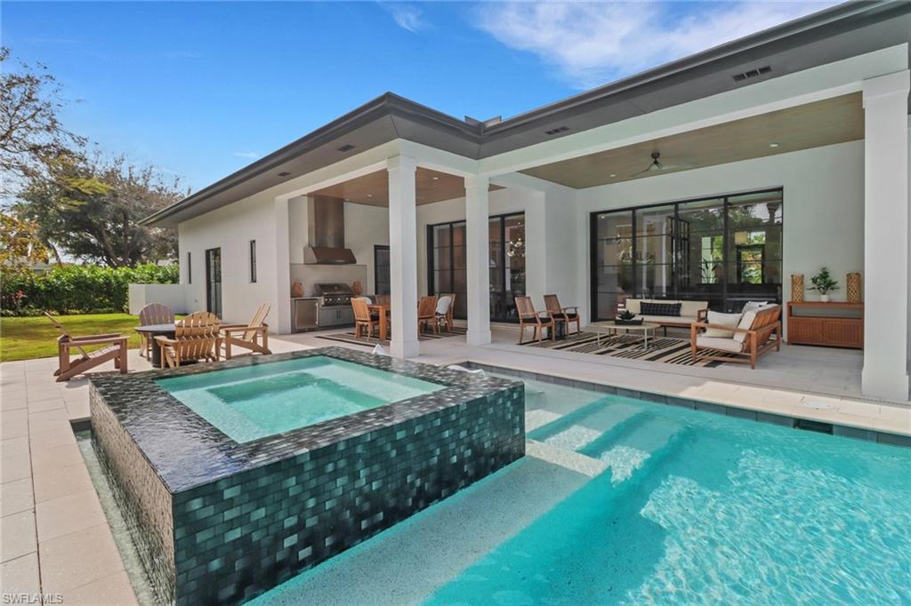 1546 Mandarin Road Naples, FL 34102 - Photo 36 of 48 View of swimming pool featuring an in ground hot tub, ceiling fan, a patio, and outdoor lounge area