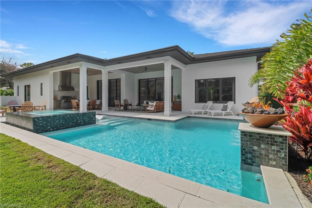 1546 Mandarin Road Naples, FL 34102 - Photo 38 of 48 View of swimming pool with ceiling fan, grilling area, a patio area, and an outdoor hangout area