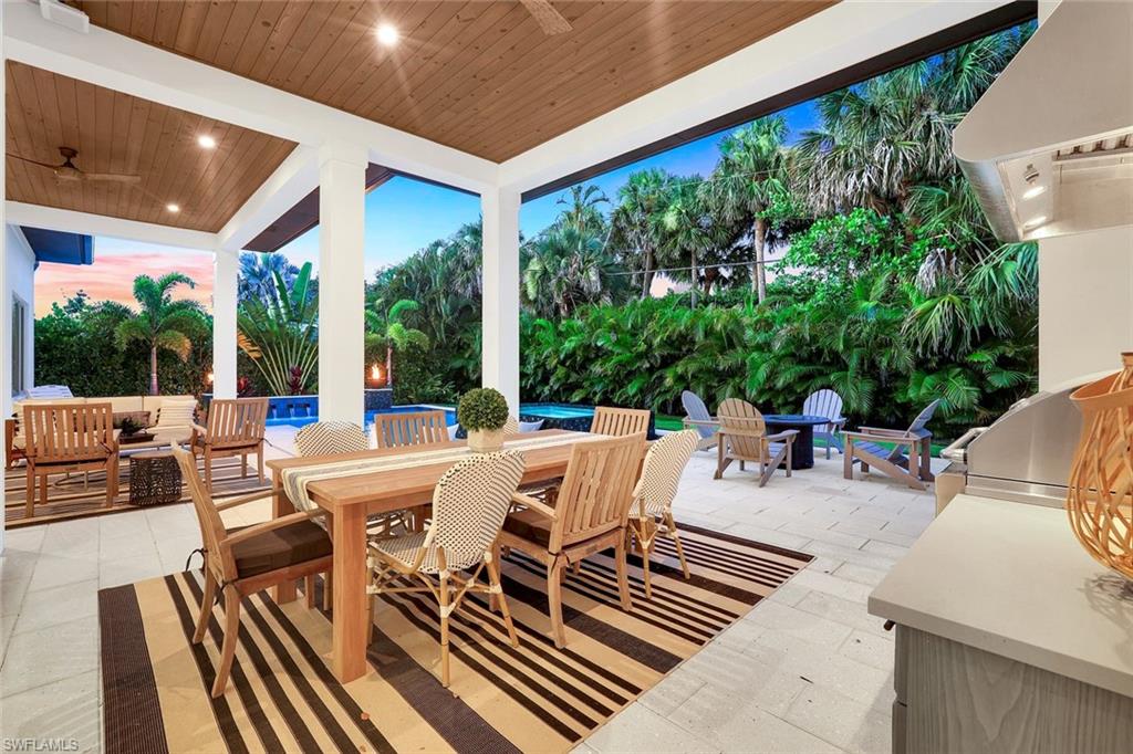 1546 Mandarin Road Naples, FL 34102 - Photo 42 of 48 View of patio featuring outdoor dining area, an outdoor pool, ceiling fan, and a grill
