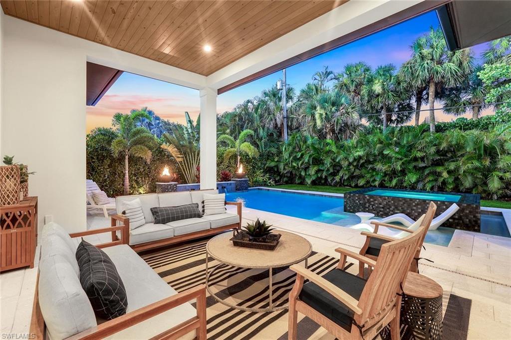 1546 Mandarin Road Naples, FL 34102 - Photo 43 of 48 Swimming pool with a patio and an outdoor living space