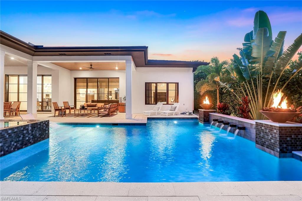 1546 Mandarin Road Naples, FL 34102 - Photo 45 of 48 Pool at dusk featuring an outdoor pool, a patio area, and an outdoor living space