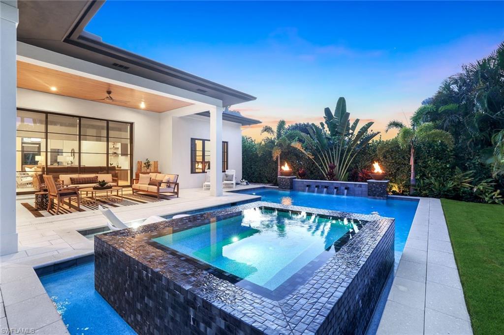 1546 Mandarin Road Naples, FL 34102 - Photo 46 of 48 View of swimming pool with a patio, a pool with connected hot tub, a ceiling fan, and outdoor lounge area