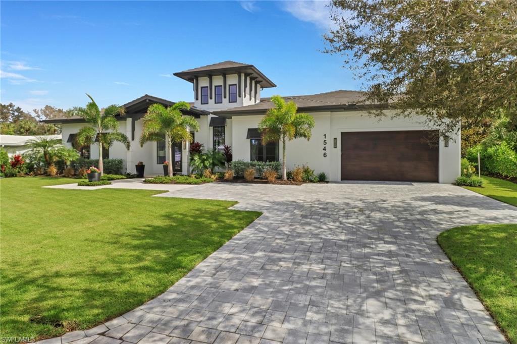 1546 Mandarin Road Naples, FL 34102 - Photo 5 of 48 View of front of property with a front yard and a garage
