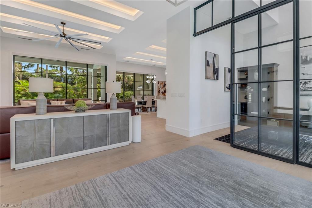 1546 Mandarin Road Naples, FL 34102 - Photo 6 of 48 Living room with a chandelier and light hardwood / wood-style floors