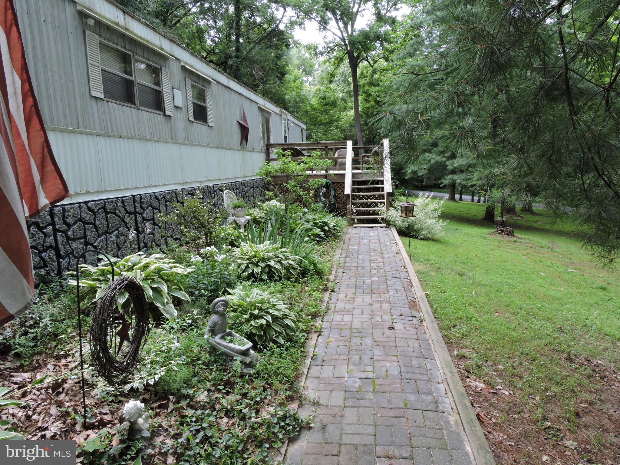 Brick walk leads to the large front deck great for