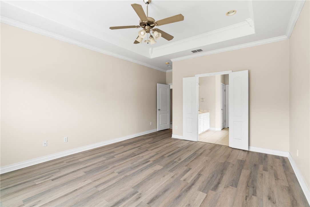 8205 Tango Circle Corpus Christi, TX 78414 - Photo 11 of 22 an empty room with wooden floor and a ceiling fan