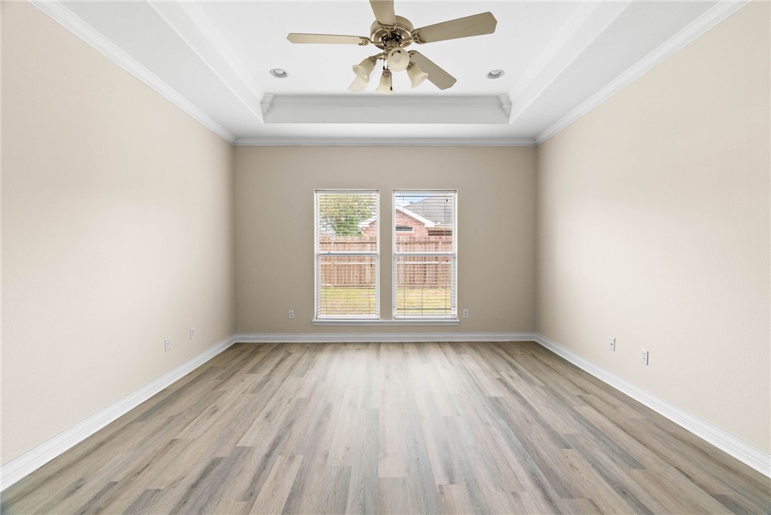 8205 Tango Circle Corpus Christi, TX 78414 - Photo 14 of 22 an empty room with wooden floor chandelier fan and windows