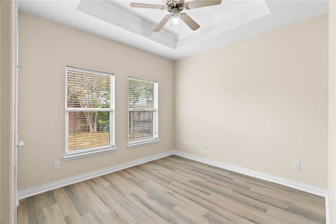 8205 Tango Circle Corpus Christi, TX 78414 - Photo 16 of 22 an empty room with wooden floor fan and windows