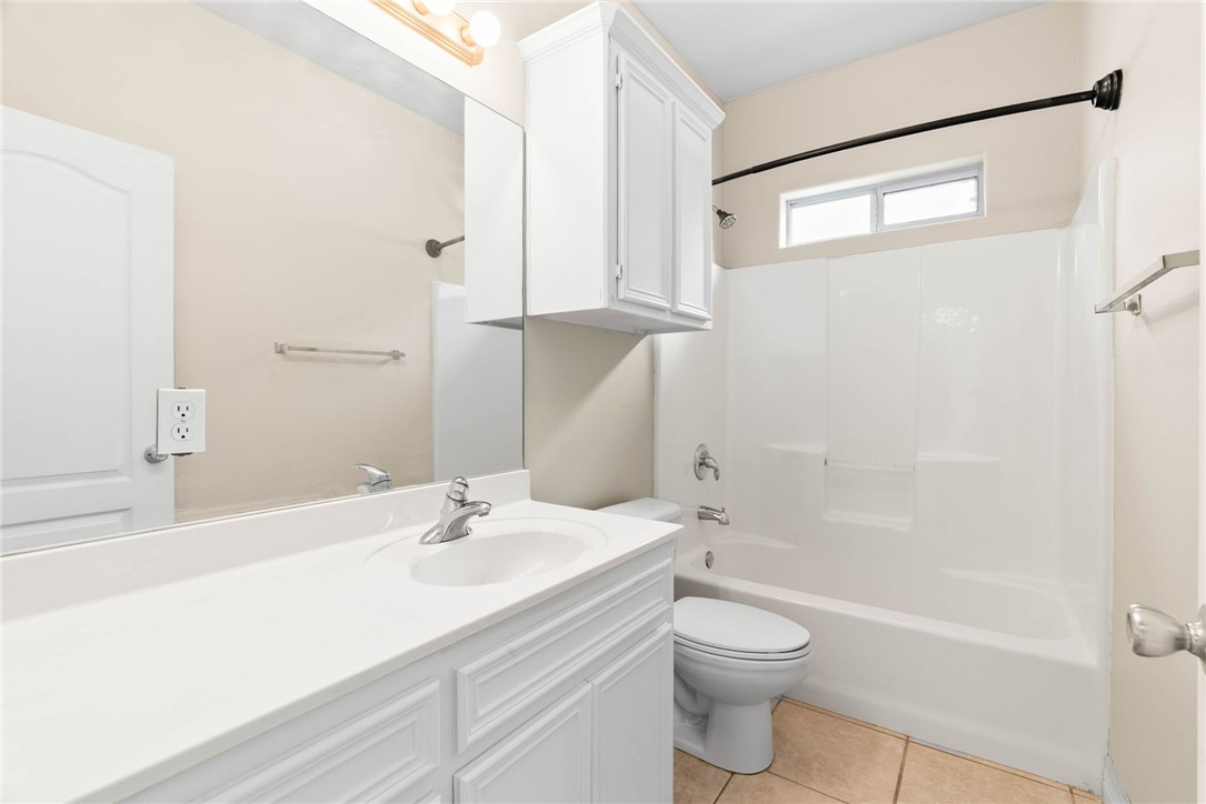 8205 Tango Circle Corpus Christi, TX 78414 - Photo 17 of 22 a bathroom with a sink a toilet and shower