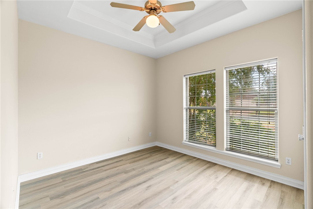 8205 Tango Circle Corpus Christi, TX 78414 - Photo 19 of 22 an empty room with wooden floor fan and windows