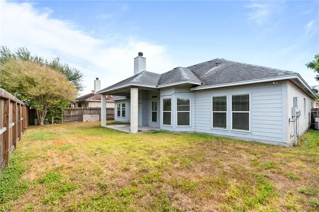 a front view of a house with a garden and yard