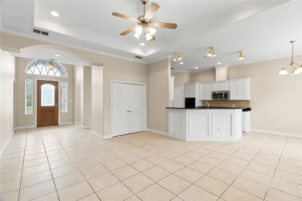 a view of kitchen with a sink dishwasher a refrigerator and a dining table with wooden floor