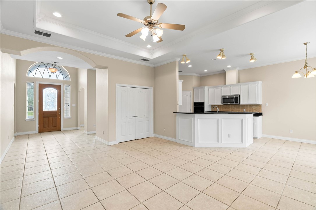 8205 Tango Circle Corpus Christi, TX 78414 - Photo 3 of 22 a view of kitchen with a sink dishwasher a refrigerator and a dining table with wooden floor