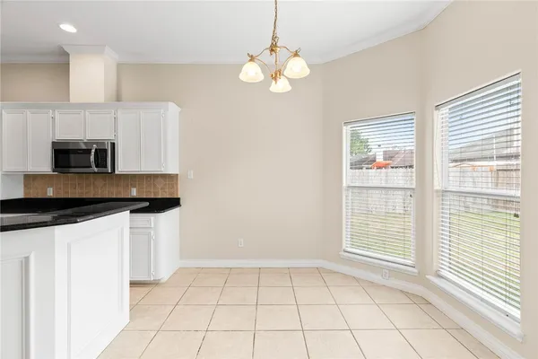 a kitchen with stainless steel appliances a sink a stove a microwave and cabinets