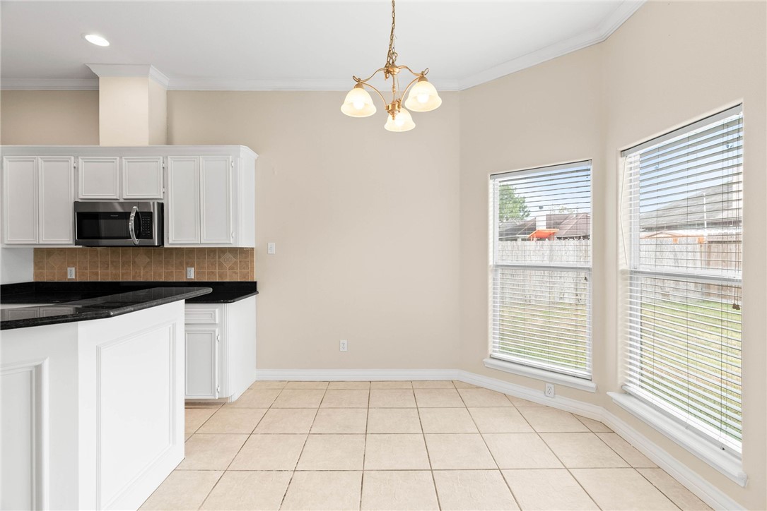 8205 Tango Circle Corpus Christi, TX 78414 - Photo 10 of 22 a kitchen with stainless steel appliances a sink a stove a microwave and cabinets