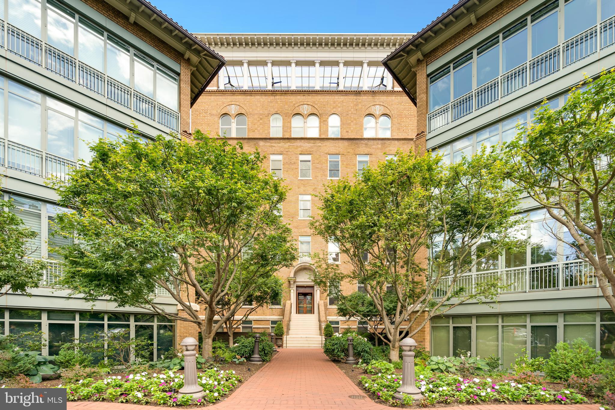2425 L Street Northwest, Unit 211 Washington, DC 20037 - Photo 2 of 43 a front view of a building with a garden