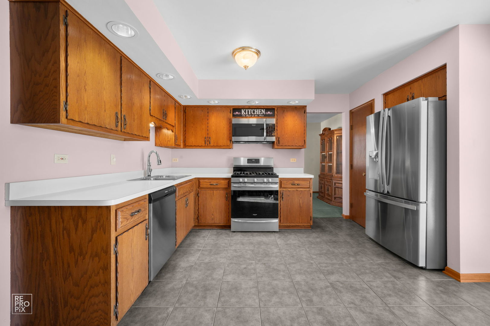 3235 192nd Street Lansing, IL 60438 - Photo 5 of 28 a kitchen with stainless steel appliances granite countertop a refrigerator sink and stove