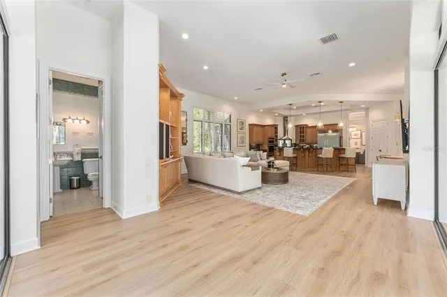 a living room with furniture large window and a flat screen tv