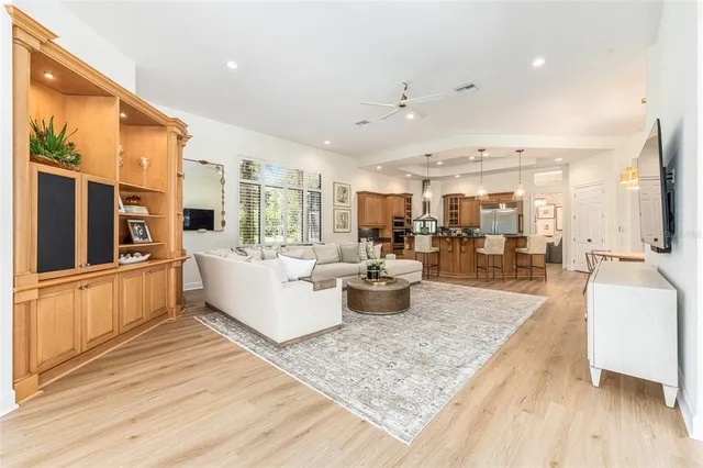 a kitchen with stainless steel appliances kitchen island granite countertop a stove a sink and a refrigerator