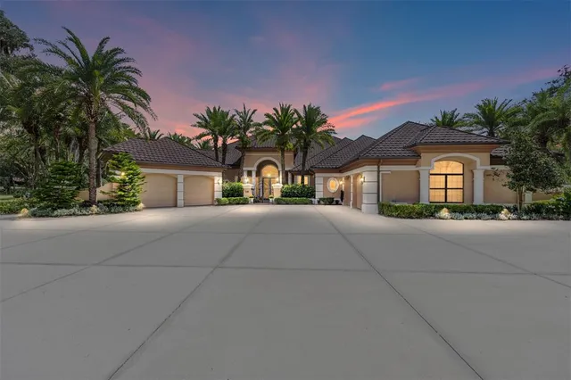 a front view of a house with a yard and potted plants