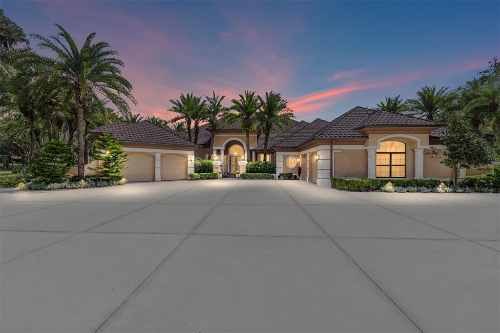 708 Southeast 44th Road Ocala, FL 34480 - Photo 2 of 76 a front view of a house with a yard and potted plants