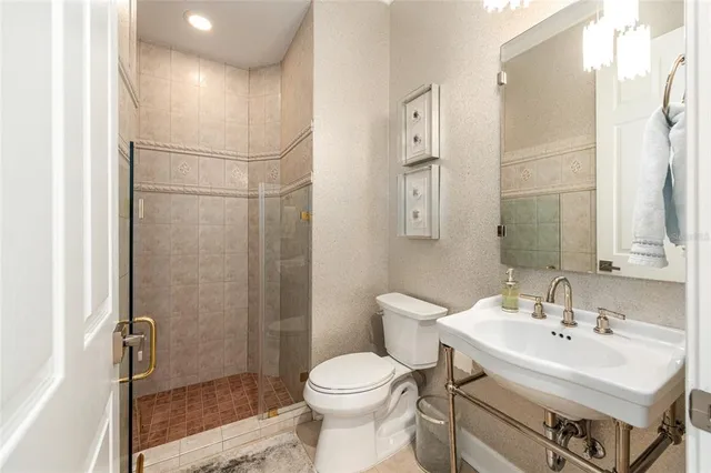 a view of a bathroom with a sink a mirror and a bathtub