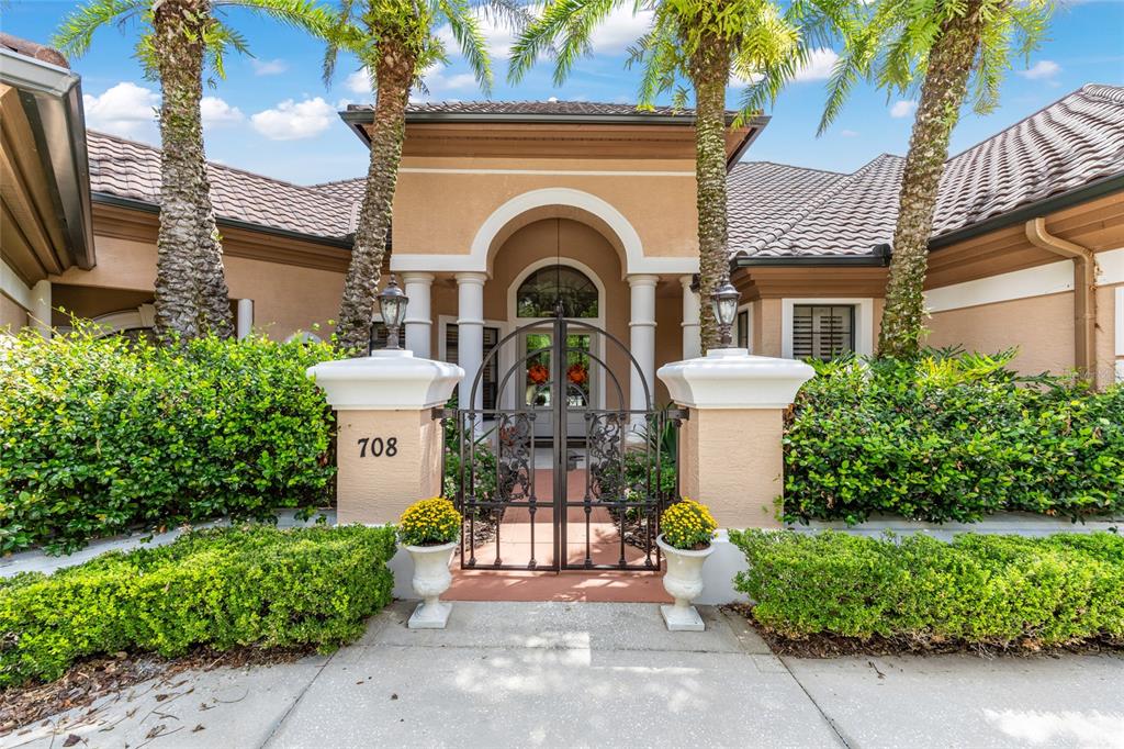 708 Southeast 44th Road Ocala, FL 34480 - Photo 3 of 76 a front view of a house with a garden